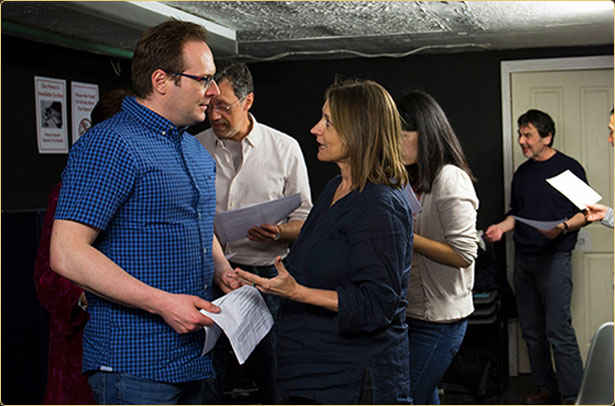 Arek Zasowski in conversation with acting coach Valerie Dent during a 2017 acting workshop in London, surrounded by fellow actors in rehearsal