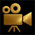 Gold movie camera icon on black background, symbolizing Arek Zasowski’s cinematic work and filmography